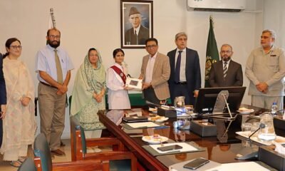 Federal Minister Giving tablet to FBISE 2nd Position Holder