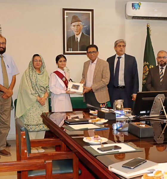 Federal Minister Giving tablet to FBISE 2nd Position Holder