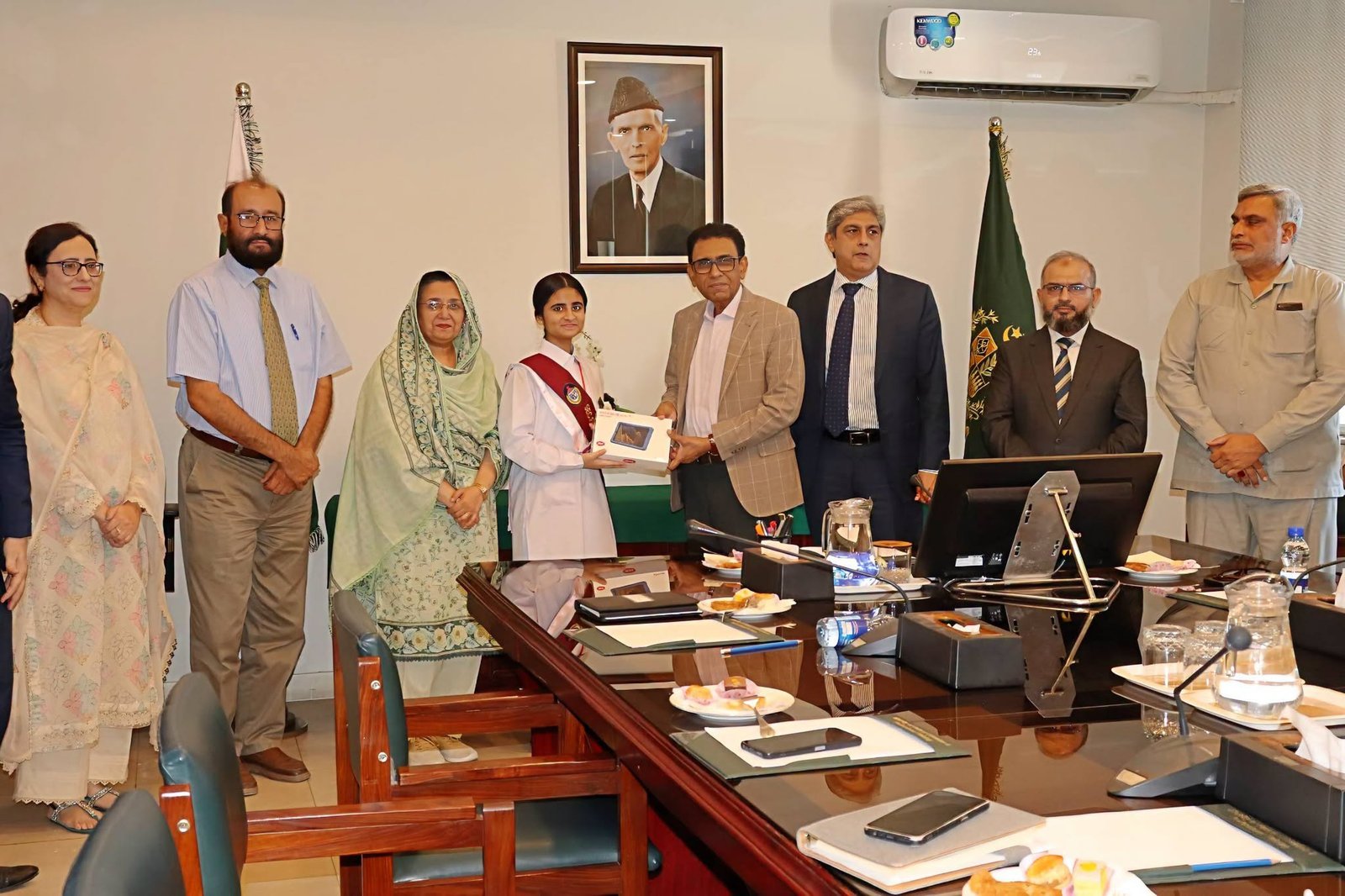 Federal Minister Giving tablet to FBISE 2nd Position Holder